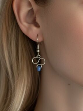 Elegant Polished Silver Infinity Earrings with Blue Accents
